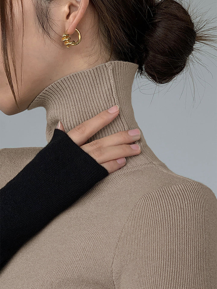 Haut en tricot à col montant à manches longues et patchwork asymétrique