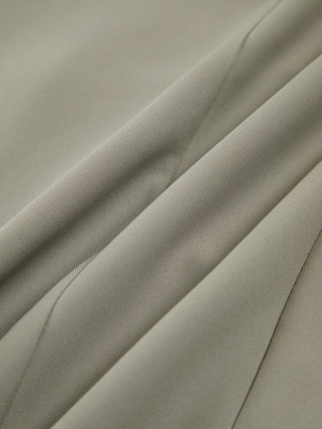 Gilet sans manches asymétrique vert grisâtre avec bouton
