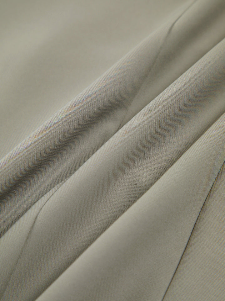 Gilet sans manches asymétrique vert grisâtre avec bouton