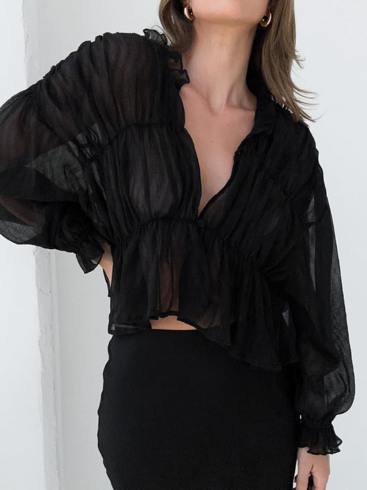 Blouse en mousseline transparente à volants