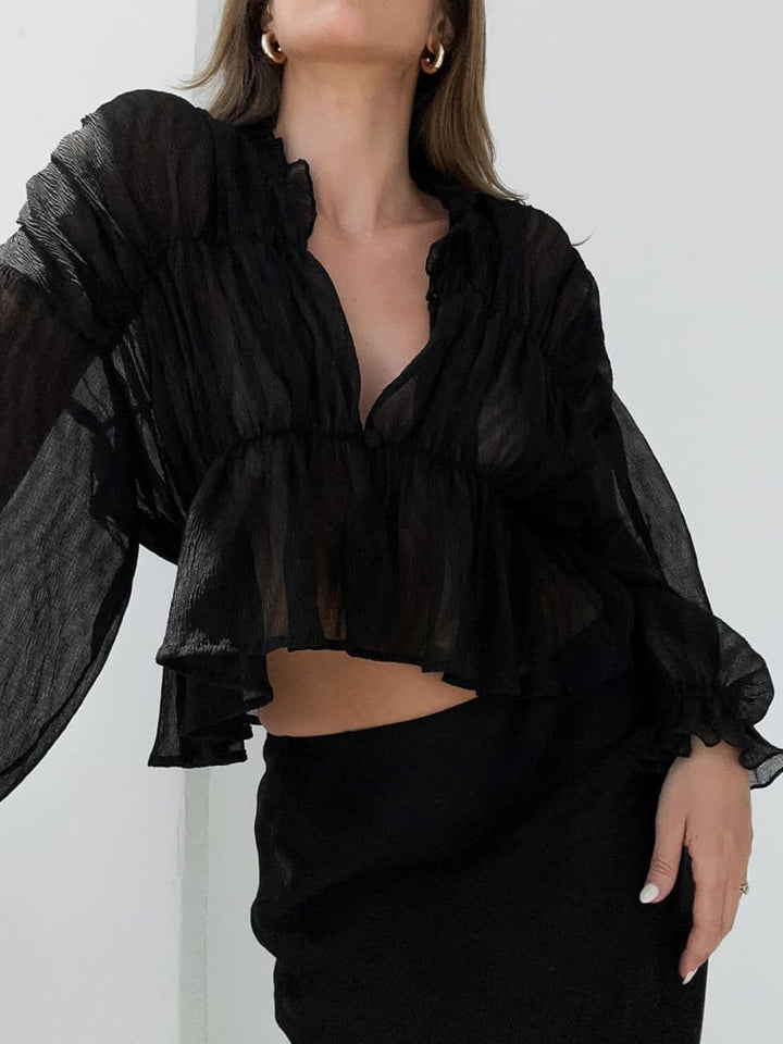Blouse en mousseline transparente à volants