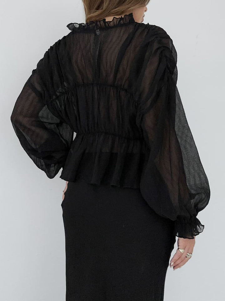 Blouse en mousseline transparente à volants
