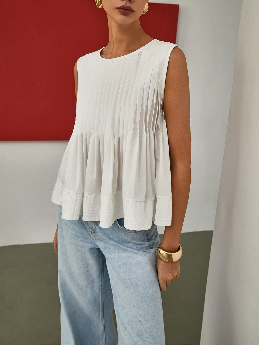 Blouse sans manches à basque plissée
