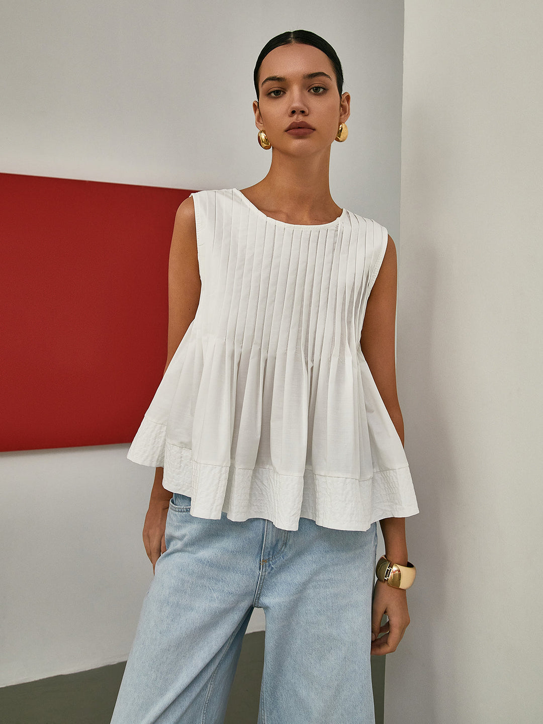 Blouse sans manches à basque plissée