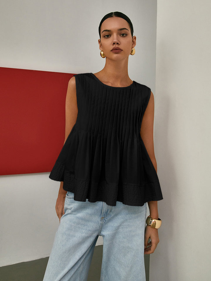 Blouse sans manches à basque plissée