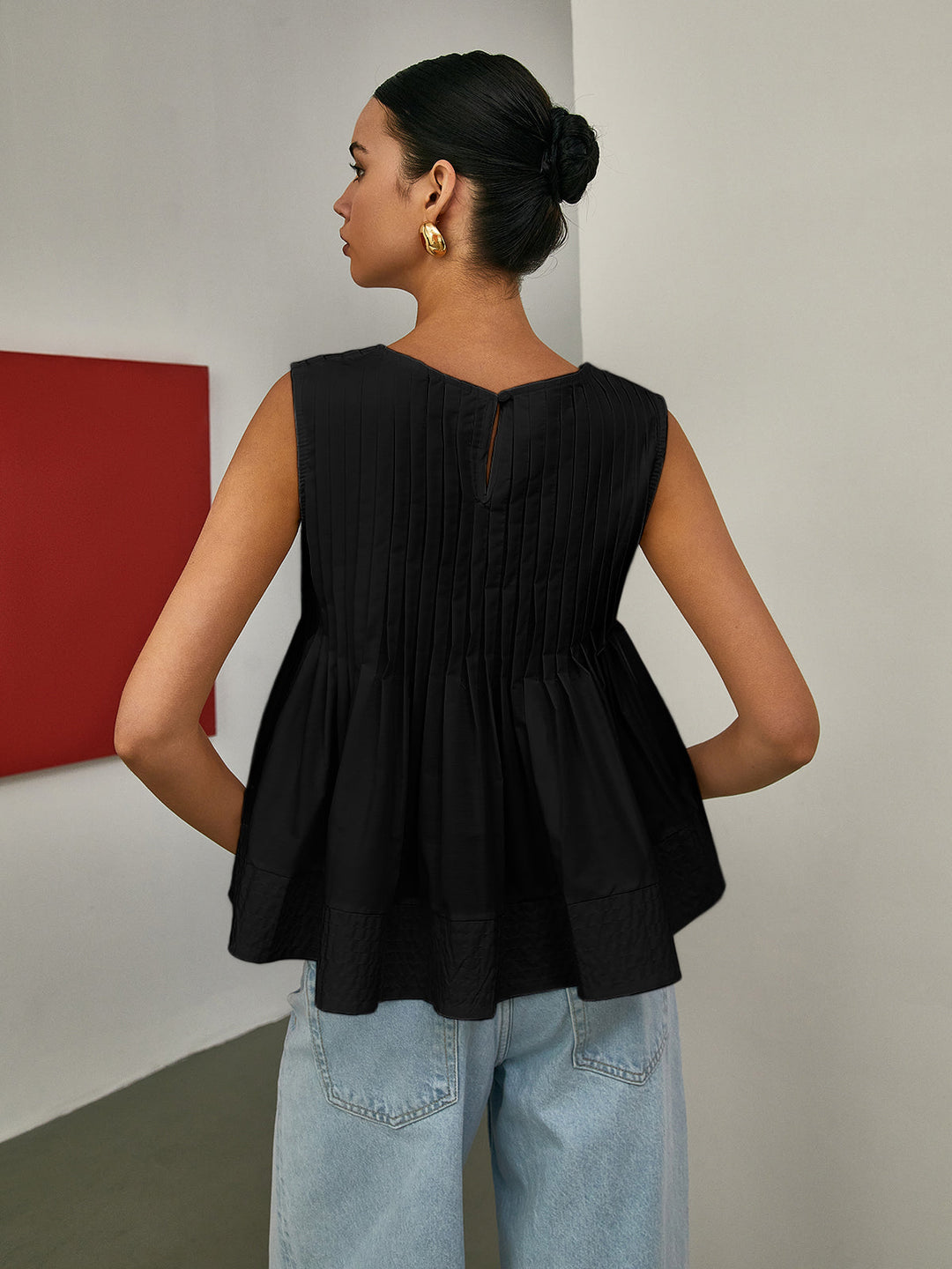 Blouse sans manches à basque plissée