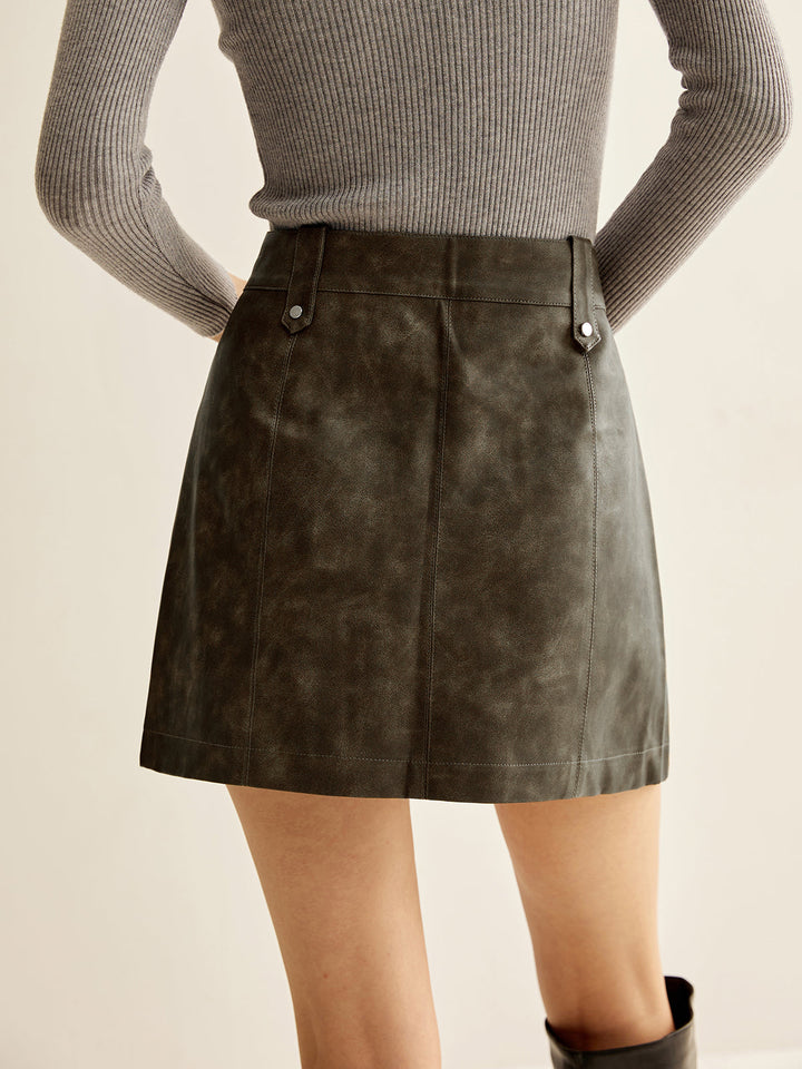 Jupe en cuir synthétique à poches asymétriques zippées