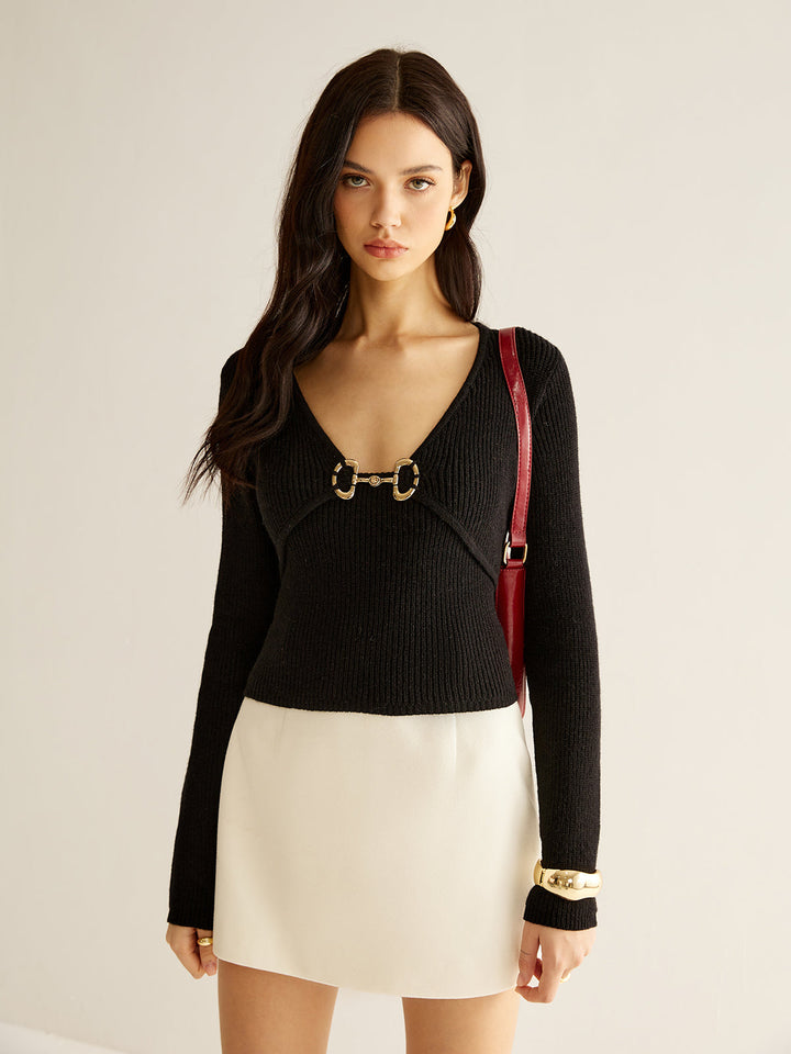 Pull en maille à col en V avec détails métalliques