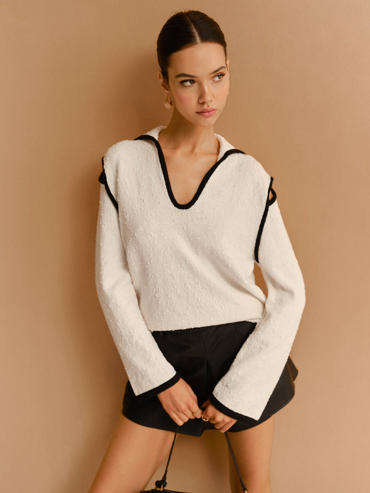 Pull à col à revers avec découpes et passepoil contrasté