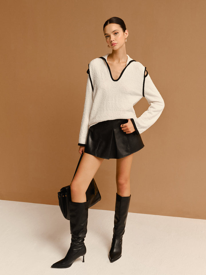 Pull à col à revers avec découpes et passepoil contrasté