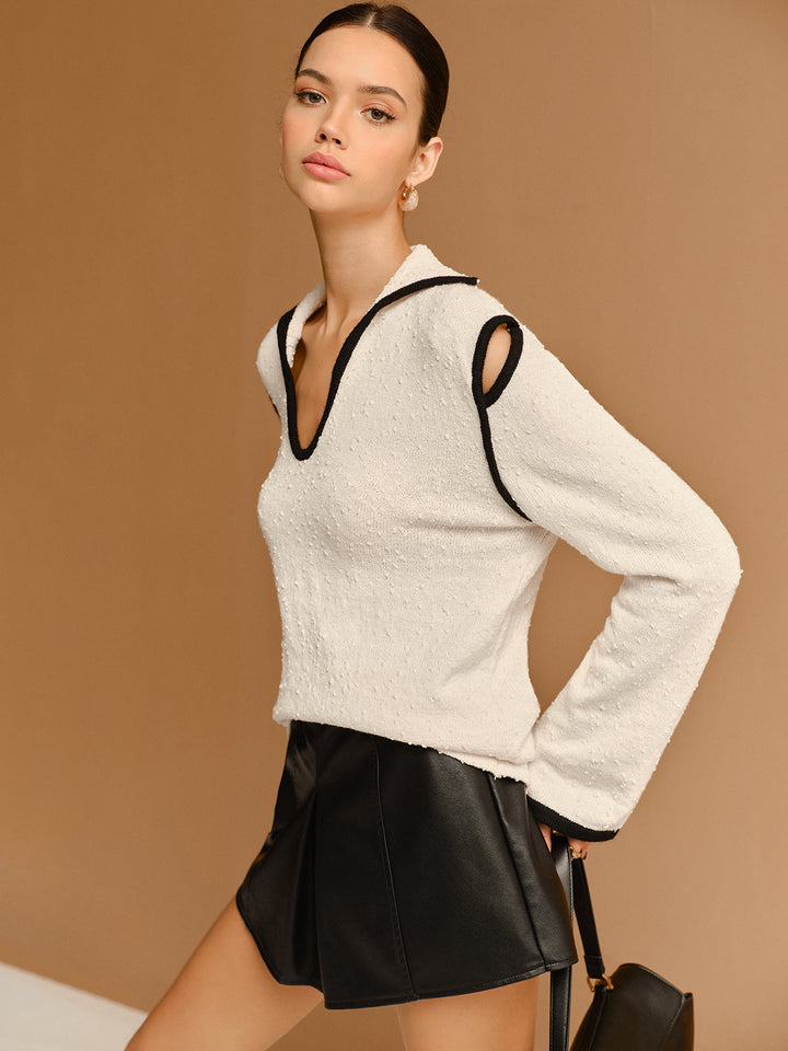 Pull à col à revers avec découpes et passepoil contrasté