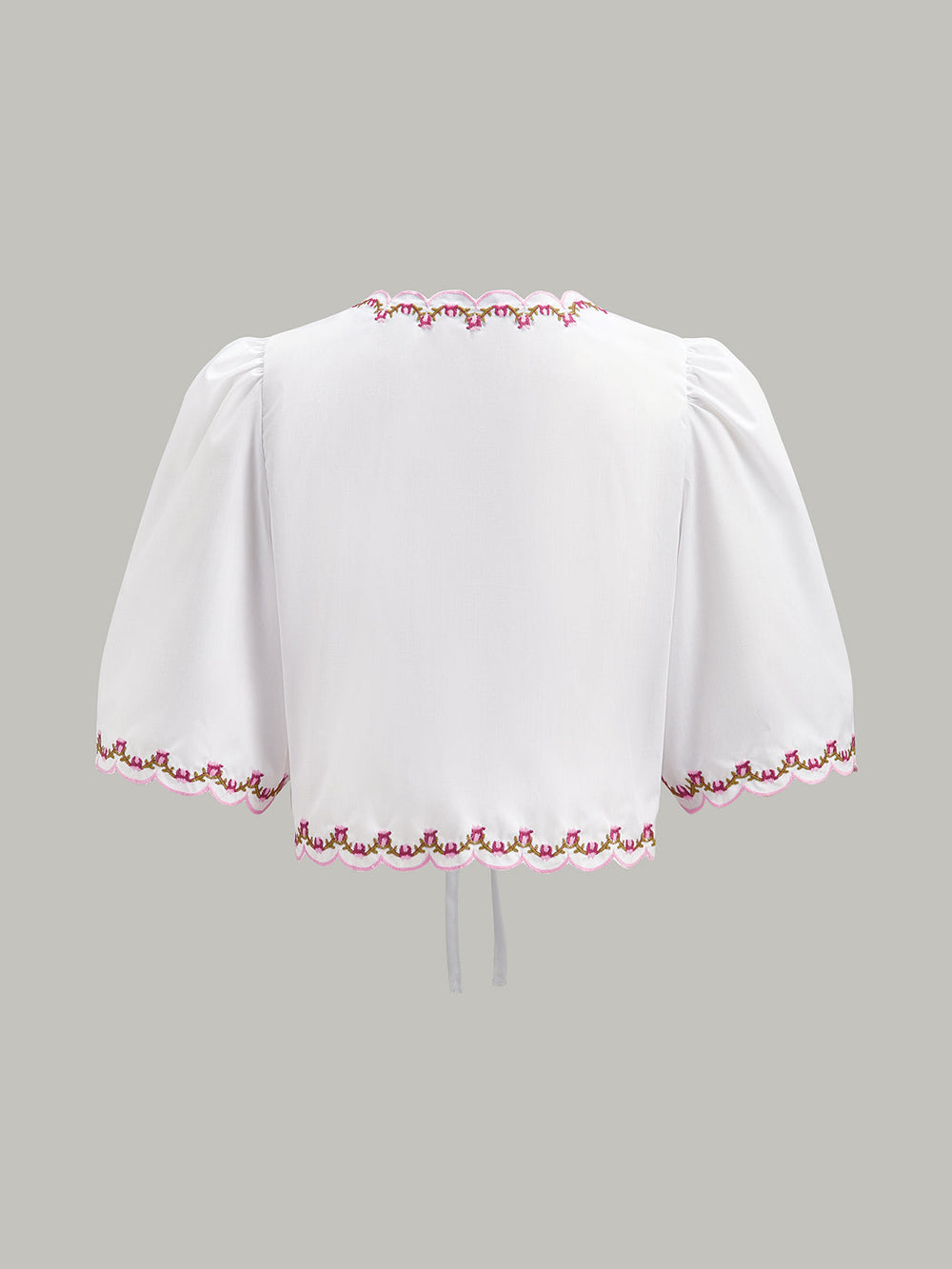 Blouse à manches bouffantes avec bordure festonnée et nœud brodé