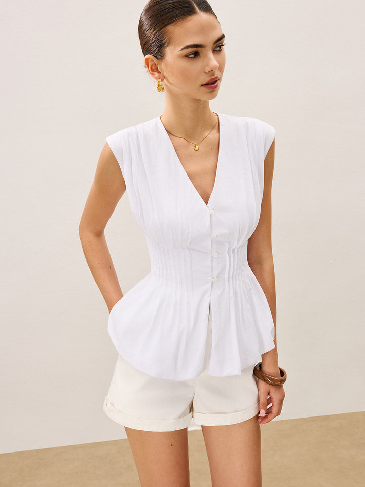 Blouse à col en V avec basque plissée