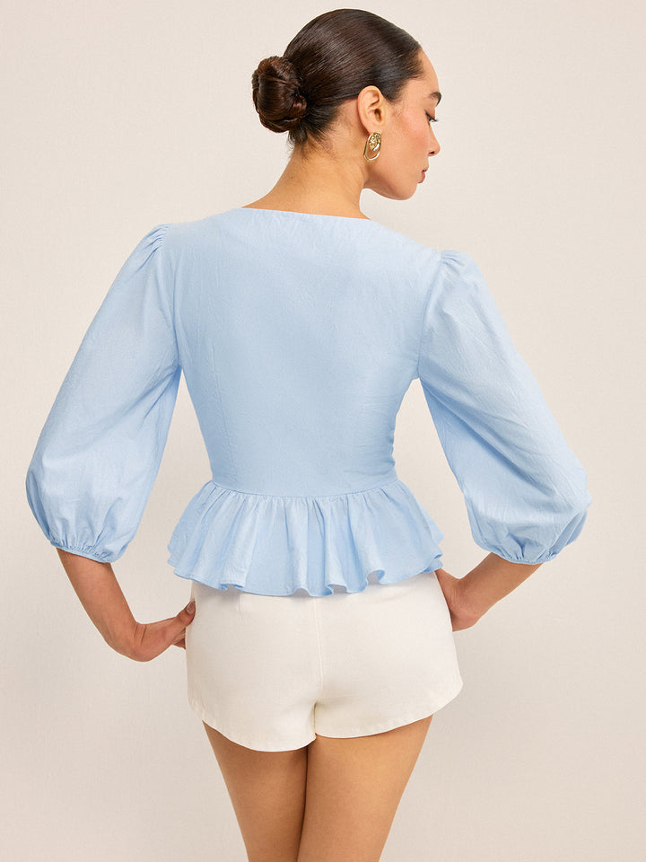 Haut Peplum à col en V festonné avec manches bouffantes