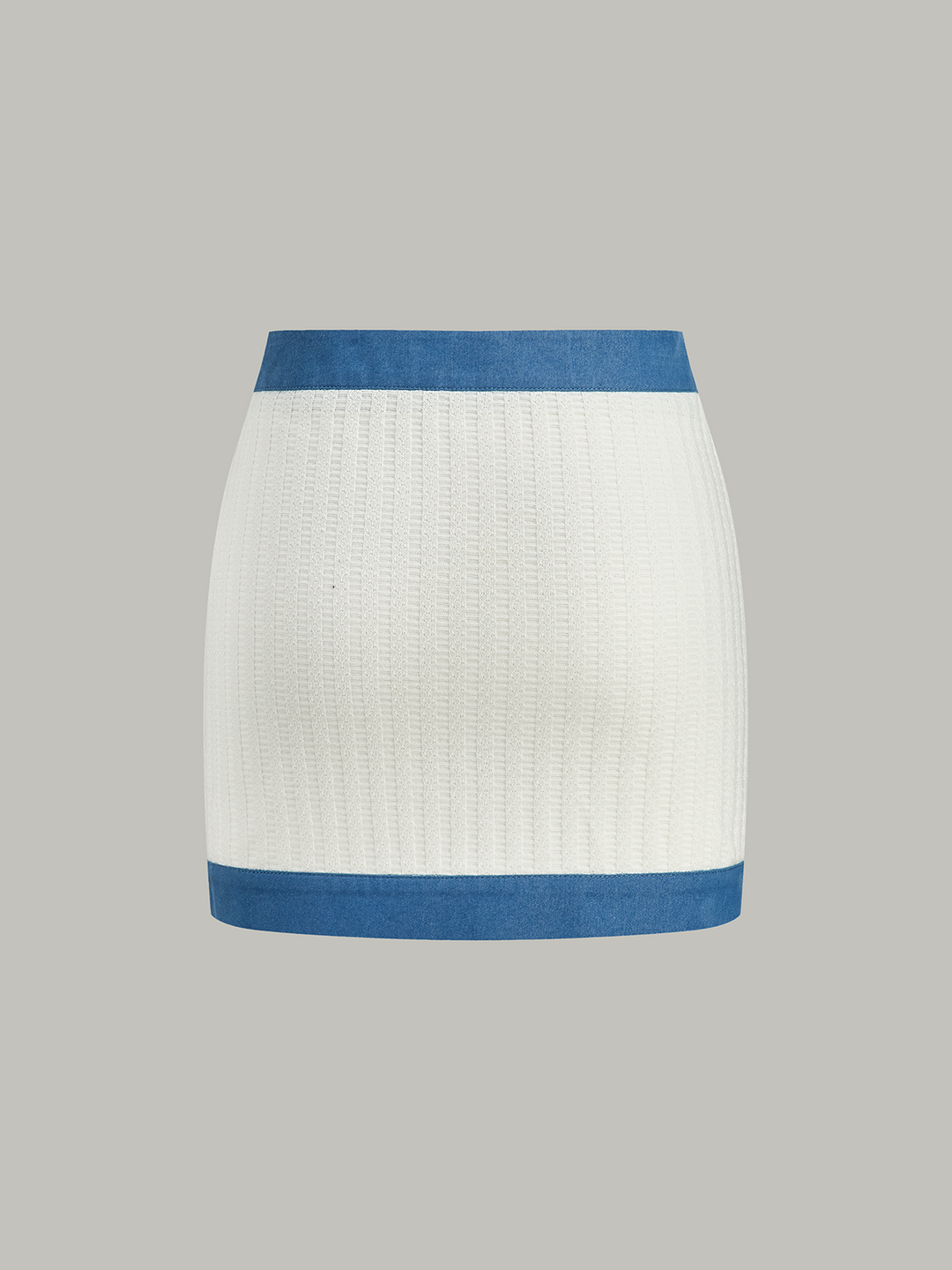 Mini-jupe en tricot avec bordure en jean et bouton en métal
